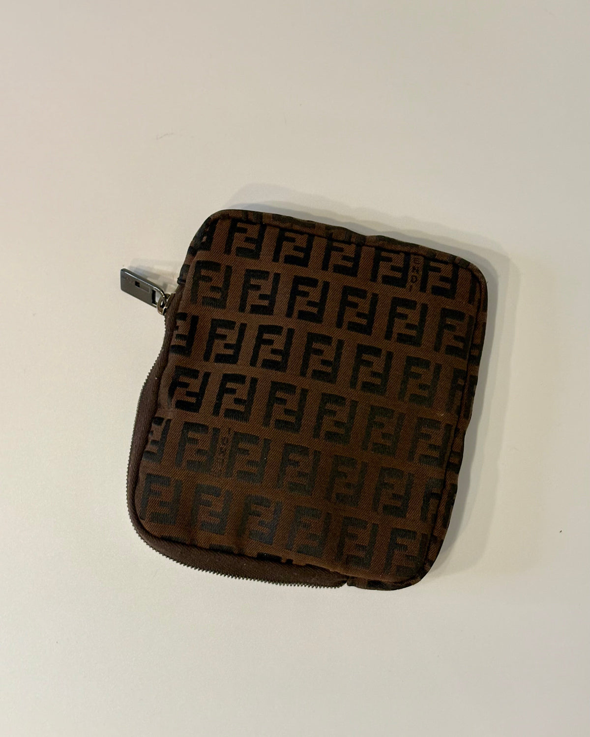 Fendi brown zip pouch featuring the iconic FF monogram pattern