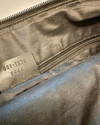 Detail photo of the serial number tag inside the Gucci bag, showing code 001.1206 3444.