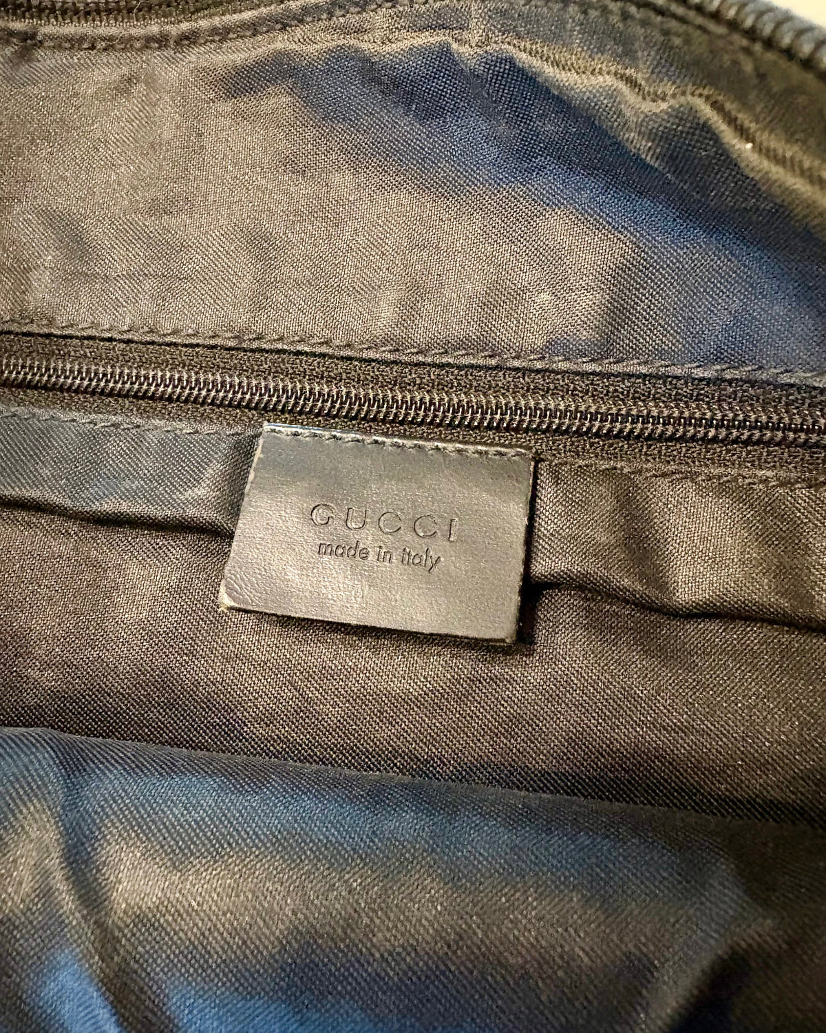 Close-up of the Gucci “made in Italy” leather tag inside the bag.
