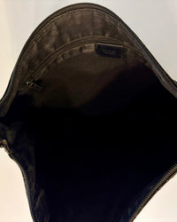 Close-up of the shoulder strap of the Gucci bag, showing the combination of suede, textile and leather trim.