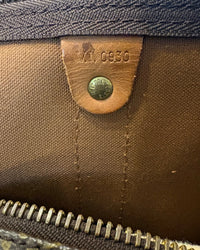 Interior view of the Louis Vuitton Keepall Bandoulière 55 showing the leather tab with date code VI0930 stamped inside.