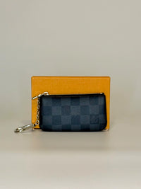 Two wallets, one orange and one black with a pattern, on a light gray background.