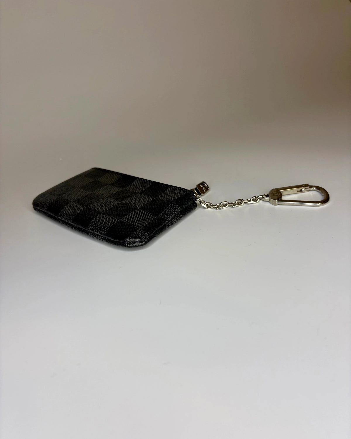 Black checkered keychain pouch on a white background