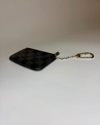 Black checkered keychain pouch on a white background