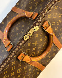 top view of the Louis Vuitton Keepall 55 showing the double handles, gold-tone zipper and classic monogram canvas.