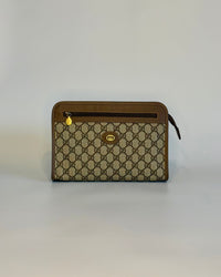 Vintage Gucci GG Supreme pouch in brown canvas, shown from the front with gold-tone details and leather trim.