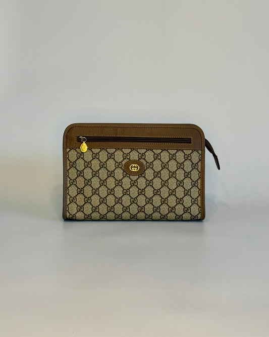Vintage Gucci GG Supreme pouch in brown canvas, shown from the front with gold-tone details and leather trim.