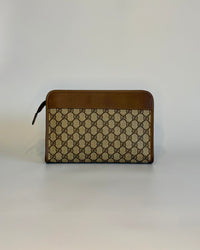 Backside of the vintage Gucci GG Supreme document pouch with brown leather top panel and monogram canvas.