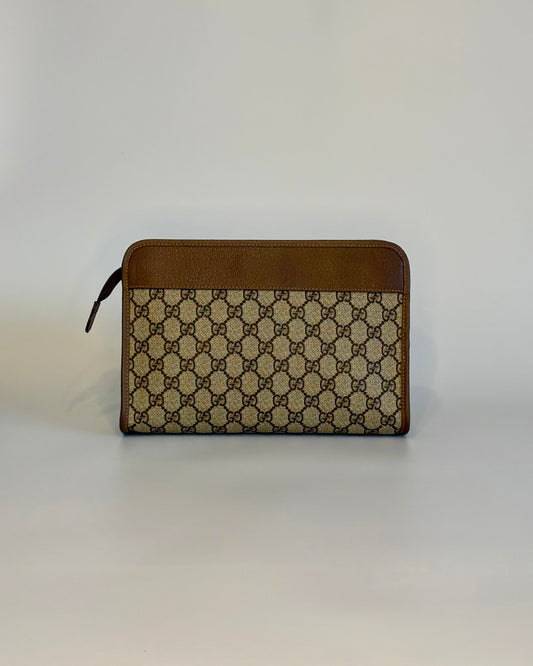 Backside of the vintage Gucci GG Supreme document pouch with brown leather top panel and monogram canvas.