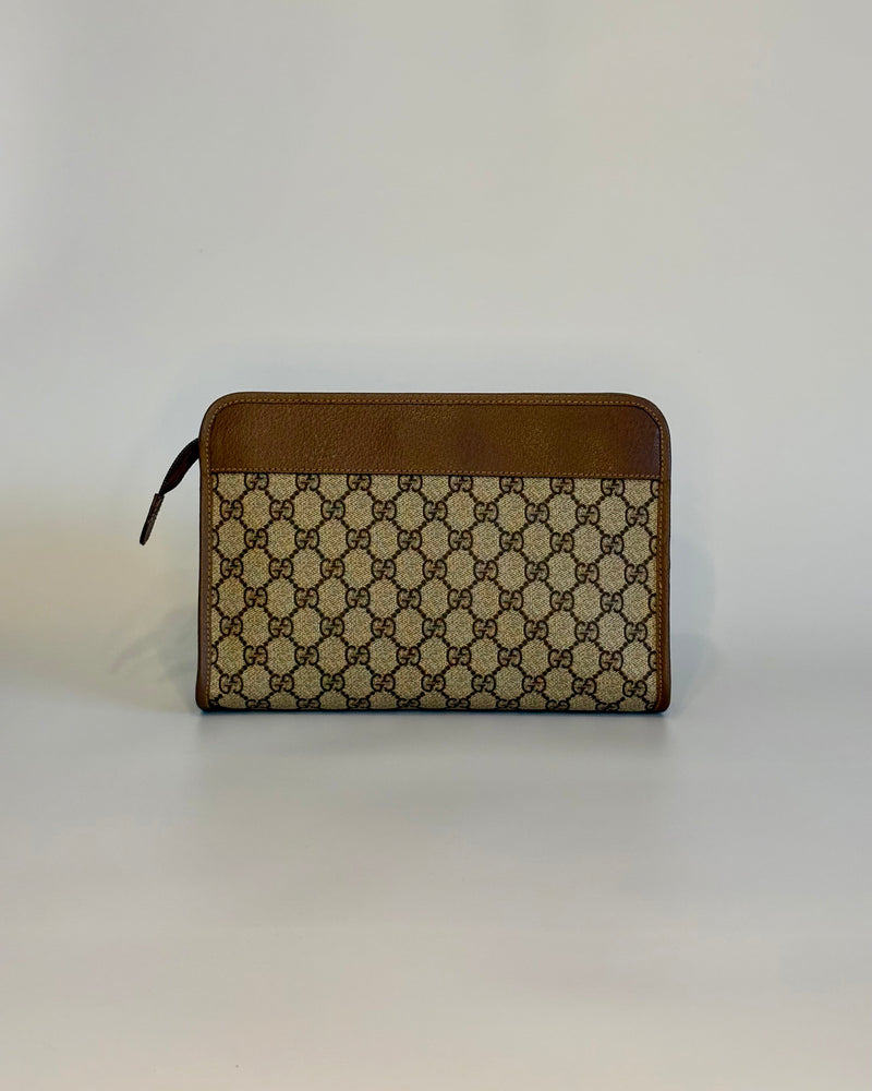 Backside of the vintage Gucci GG Supreme document pouch with brown leather top panel and monogram canvas.